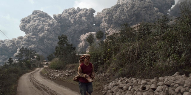 Feb. 1, 2014: A villager runs as Mount Sinabung erupt at Sigarang-Garang village in Karo district, Indonesia's North Sumatra province.