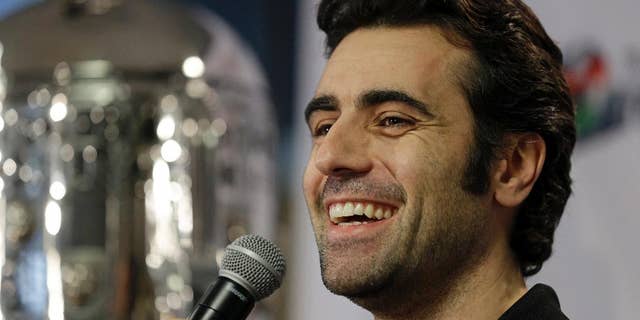 FILE - In this Dec. 19, 2013 file photo, Dario Franchitti, of Scotland, answers a question during his first public appearance since a crash ended his IndyCar career during a press conference in Indianapolis. The three-time Indy 500 winner scoots through the Indianapolis Speedway paddock in a golf cart. Aside from a team meeting here or there, he marches to a wide-open schedule. Retirement suits the Scotsman well. (AP Photo/Michael Conroy, File)