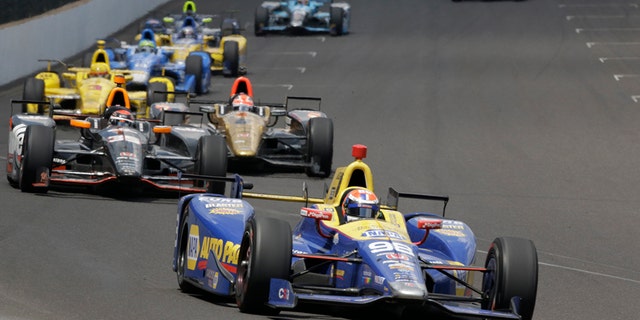 Alexander Rossi leads the field on his way to winning the 100th running of the Indianapolis 500 auto race at Indianapolis Motor Speedway in Indianapolis, Sunday, May 29, 2016. (AP Photo/R Brent Smith)