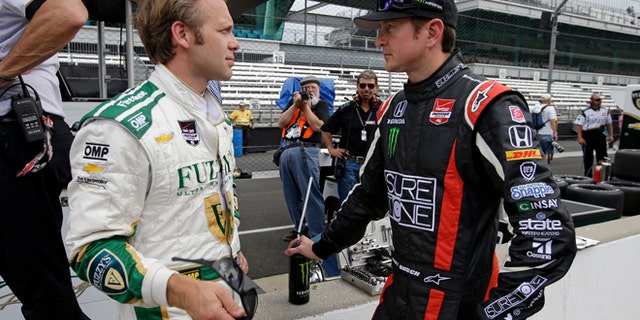 May 11, 2014: Kurt Busch, right, talks with Ed Carpenter during practice for Indianapolis 500 IndyCar auto race at the Indianapolis Motor Speedway in Indianapolis. (AP)