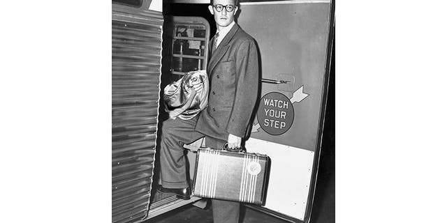 Leslie Dillon ascends an ominously worded bus on his release, threatening to sue the city authorities for false imprisonment in 'at least six figures.'