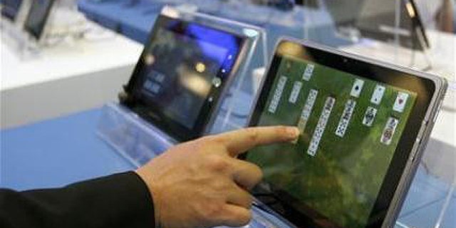 May 31, 2011: A visitor plays with a tablet PC at the Intel booth during the Computex 2011 computer fair at the TWTC Nangang exhibition hall in Taipei.