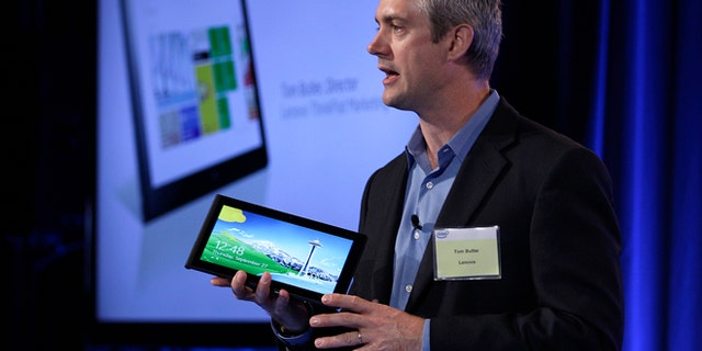 Sept. 27, 2012: Tom Butler, Director of Lenovo ThinkPad Marketing, speaks while holding a Lenovo tablet Thursday in San Francisco. Intel previewed a wave of tablet computers powered by a microprocessor that the company redesigned to make a bigger dent in the rapidly growing mobile market.