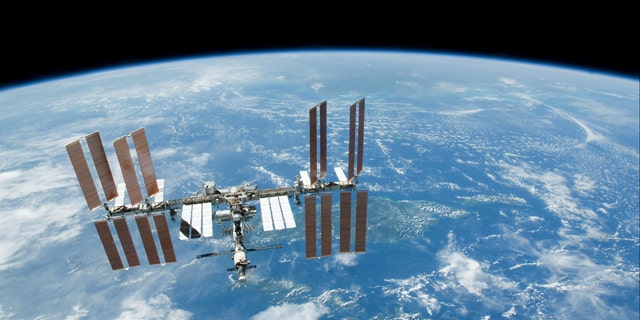 FILE - This Feb. 19. 2010 file photo provided by NASA shows the International Space Station with Earth's horizon as a backdrop. Several power systems have been shut down aboard the International Space Station after a cooling system malfunctioned. NASA says in a posting on its website that one of two cooling loops aboard the space station was shut down Saturday, July 31, 2010. A module that pumps ammonia coolant to prevent equipment from overheating was still shut down early Sunday, Aug. 1. (AP Photo/NASA, File)