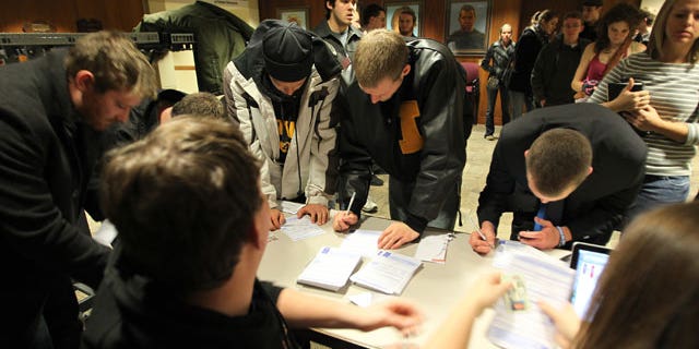 Caucus voters filling out same-day voter registration paperwork to participate in the 2012 Republican presidential caucus in Iowa