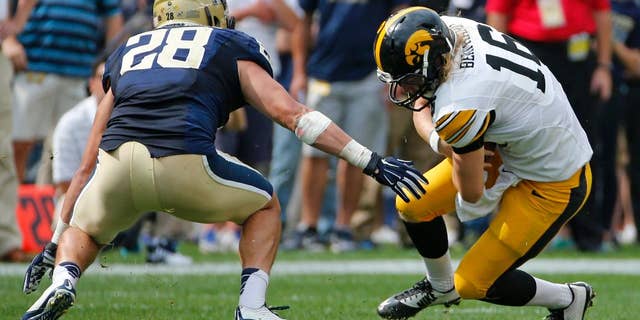 Iowa quarterback C.J. Beathard (16) slides before being tackled by Pitt linebacker Anthony Gonzalez (28) after a short gain during the fourth quarter of an NCAA college football game in Pittsburgh, Saturday, Sept. 20, 2014. Iowa won 24-20. (AP Photo/Gene Puskar)