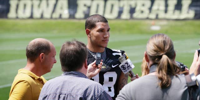 FILE - In this Aug. 4, 2014, file photo, Iowa freshman wide receiver Derrick Willies speaks to reporters during Iowa's annual college football media day in Iowa City, Iowa. Willies is leaving the program and sophomore running back LeShun Daniels Jr. is out for the rest of the season because of an undisclosed injury. Coach Kirk Ferentz says Willies is expected to transfer to be closer to his father, who is having health issues. (AP Photo/Charlie Neibergall, File)