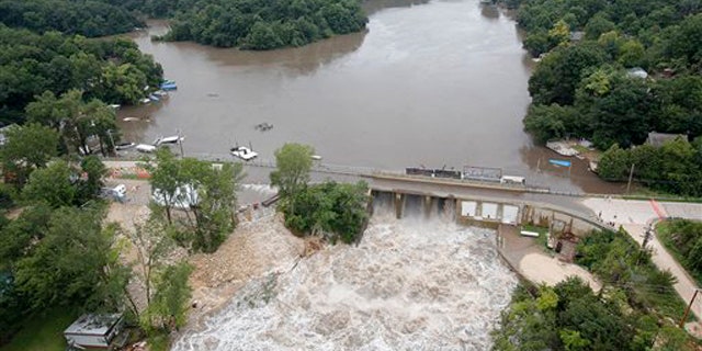 July 24, 2010: Maquoketa River water surges over the bridge of the Delhi Dam as areas surrounding the Maquoketa River continue to flood.