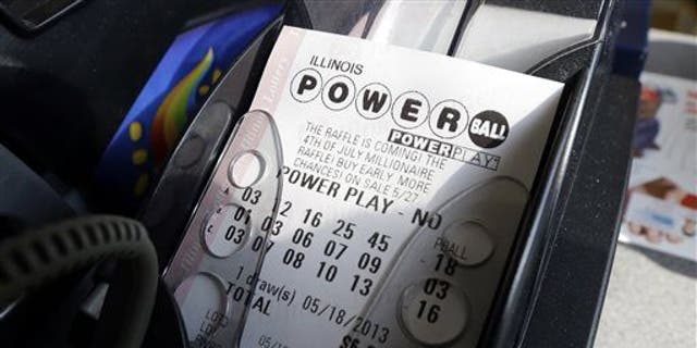 A Powerball lottery ticket is printed out of a lottery machine at a convenience store in Illinois.