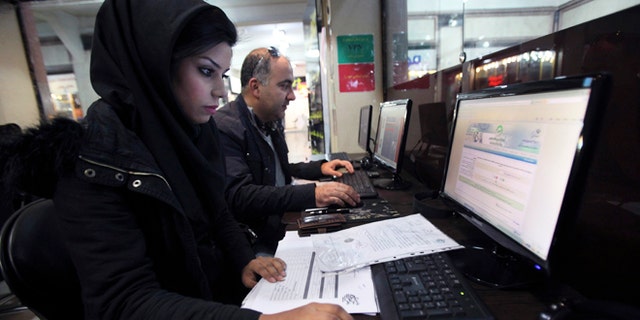 Jan. 6, 2013: Iranians surf the web in an internet cafe at a shopping center, in central Tehran, Iran. Iran's police chief says the Islamic Republic is developing new software to control social networking sites.
