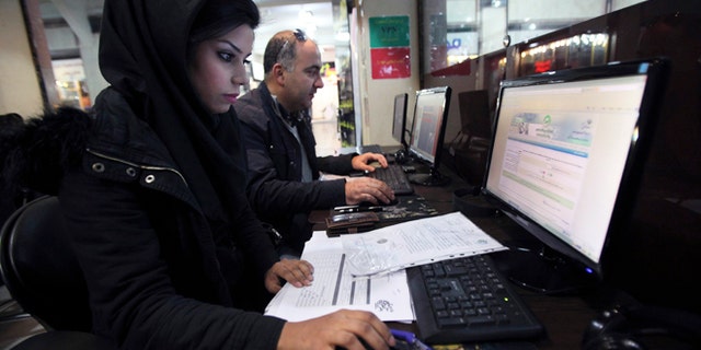 Jan. 6, 2013: Iranians surf the web in an internet cafe at a shopping center, in central Tehran, Iran. Iran's police chief says the Islamic Republic is developing new software to control social networking sites.