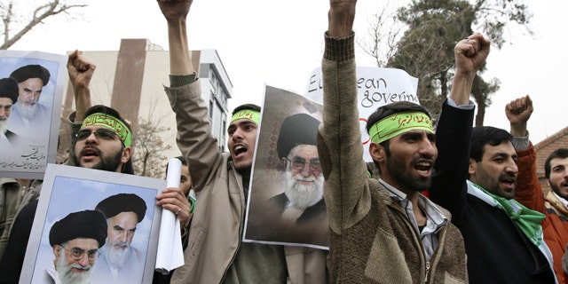 Iranian protesters shout slogans during a demonstration in Tehran February 9, 2010.