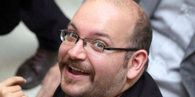 FILE - In this April 11, 2013 file photo, Jason Rezaian, an Iranian-American correspondent for the Washington Post smiles as he attends a presidential campaign of President Hassan Rouhani in Tehran. (AP Photo/Vahid Salemi, File)