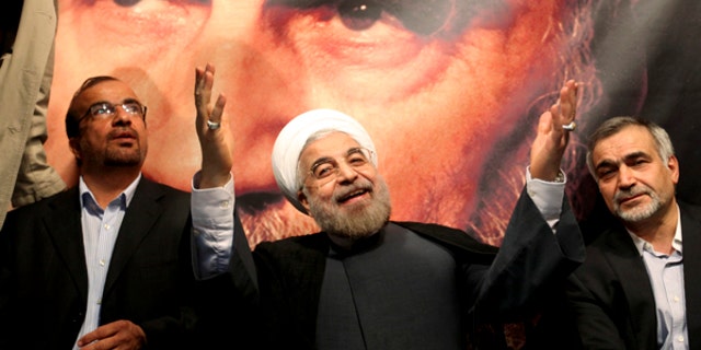 June 1, 2013: This photo shows, in front of a portrait of the late Iranian revolutionary founder Ayatollah Khomeini, presidential candidate Hasan Rowhani, a former top nuclear negotiator, center, gestures to his supporters at a rally in Tehran, Iran. Iranian pro-reform candidate, Mohammad Reza Aref, pulled out of this week's presidential election to give support to a centrist whose campaign has gained momentum in recent days. The decision by Aref is seen as a major boost for Hasan Rowhani, who now faces off against five conservative candidates Friday.