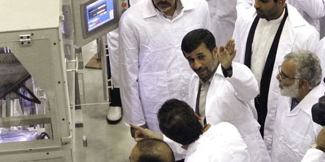 April 9, 2009: Iranian President Mahmoud Ahmadinejad, second right, gestures, as he visits Iran's Fuel Manufacturing Plant (FMP), a new facility producing uranium fuel for a planned heavy-water nuclear reactor, just outside the city of Isfahan, 255 miles south of Tehran, Iran.