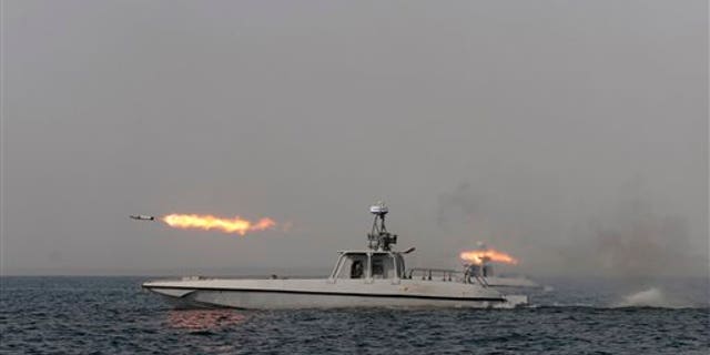 Dec. 30, 2011: An Iranian navy boat fires a missile in a drill in the sea of Oman.