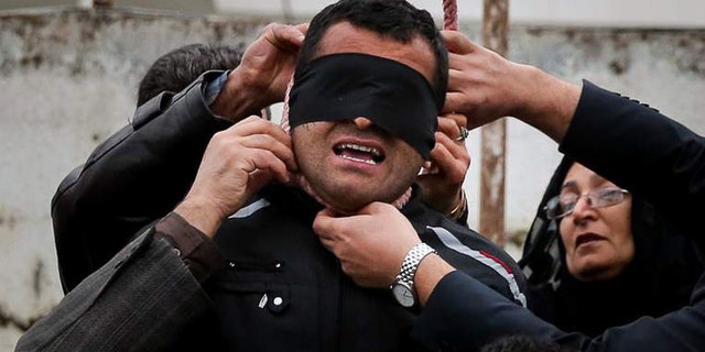 The victim's parents remove the noose.