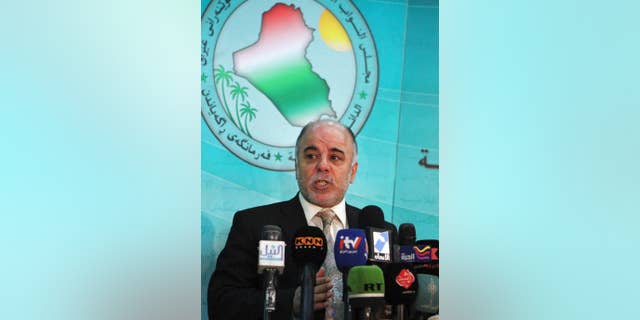 FILE - In this Saturday, Dec. 5, 2009 file photo, Shiite lawmaker Haider al-Abadi speaks to the press after an Iraqi Parliament session about the election law in Baghdad, Iraq. On Monday, Aug. 11, 2014, Iraq's largest coalition of Shiite political parties chose the Deputy Parliament Speaker Haider al-Ibadi to be its candidate to lead the government in a major defeat for incumbent Prime Minister Nouri al-Maliki just hours after he declared himself the rightful candidate and put troops on the street. Critics say the Shiite al-Maliki contributed to the crisis by monopolizing power and pursuing a sectarian agenda that alienated the country's Sunni and Kurdish minorities. (AP Photo/Karim Kadim, File)