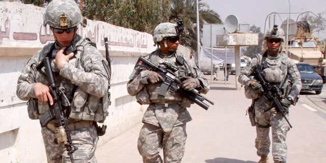 March 23, 2011: U.S. troops stand guard outside a local journalists' union office in Basra, Iraq.