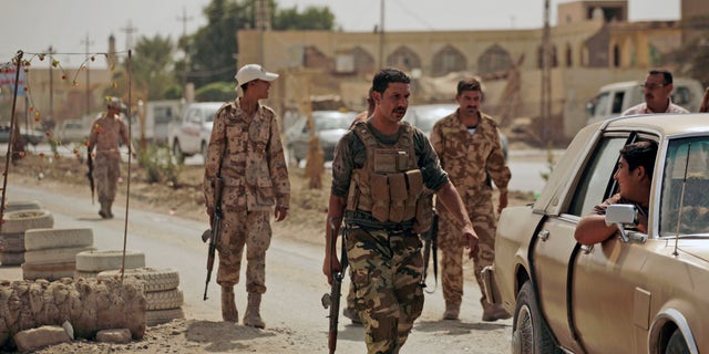 Oct. 6: Armed Sunni militiamen work at a checkpoint in Samarra, Iraq. The men are part of the Sons of Iraq, who are former Sunni insurgents now allied with U.S. and Iraqi security forces to provide security in the northern city.