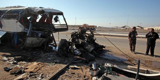 Dec. 3: The wreckage of a bus is seen at the site of a traffic accident killing 24 people in Hillah, about 60 miles south of Baghdad, Iraq.