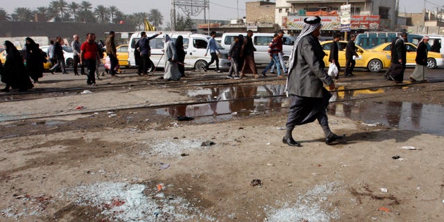 Feb. 9, 2015 - Broken glass at the scene of a suicide bomb attack at Adan Square, in a predominantly Shiite part of Baghdad, Iraq. The attack and another in the northeastern suburb of Husseiniyah in Baghdad killed at least 22 people and wounded dozens.