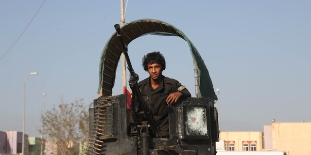 March 15, 2015 - A young volunteer militiaman on his way to the battlefield against Islamic State fighters in Tikrit, 80 miles north of Baghdad, Iraq. Kurdish forces in Iraq are investigating 2 other possible ISIS chemical weapons attacks, a top official said Monday, as authorities put an Iraqi offensive to retake Saddam Hussein's hometown on hold.