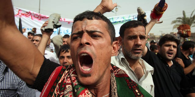 Oct. 8, 2010: Supporters of Shiite cleric Muqtada al-Sadr hold a demonstration in support of al-Sadr's political alliance with Prime Minister Nouri al-Maliki after Friday prayers in the Sadr City area of Baghdad, Iraq.