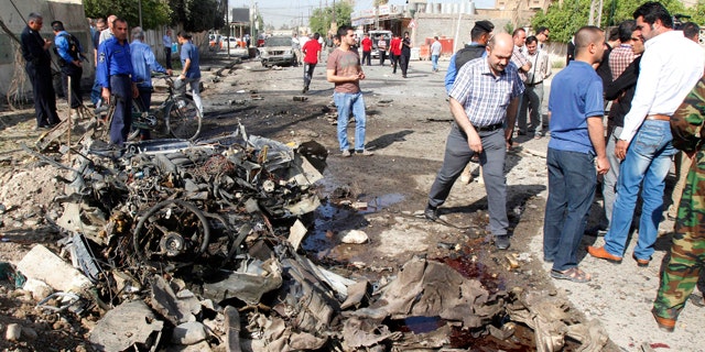 April 15, 2013: Iraqi security personnel are seen at the site of a bomb attack in Kirkuk.