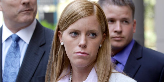 Jamie Leigh Jones, center, listens to a question along with her husband, Kallan Daigle, right, and attorney Todd Kelly, left, outside the federal courthouse Tuesday, June 14, 2011, in Houston. Opening statements began Tuesday in the civil lawsuit filed by Jones, an ex-female contractor who claims she was raped by co-workers in Iraq in 2005 while employed by a former Halliburton Co. subsidiary and then held against her will when she tried to report the assault.