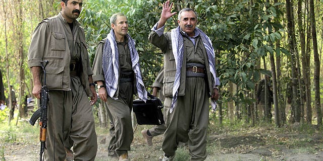 Sept. 30, 2010: Murad Karialan, right, and Bouzan Teken, center, of the Kurdistan Workers' Party, or PKK, speaks to the press in the Qandil mountain range, northern Iraq.