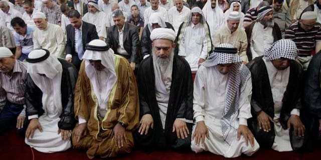 July 5, 2013: Worshippers attend joint Sunni-Shiite Friday prayers at Abdul-Qadir al-Gailani Mosque in Baghdad, Iraq. In a show of national unity, Shiite and Sunni worshippers held joint prayers Friday in a Sunni mosque in downtown Baghdad amid tight security measures.