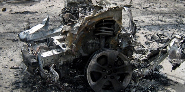 April 18: Iraqi army soldiers secure the scene of a suicide car bomb in Baghdad, Iraq.