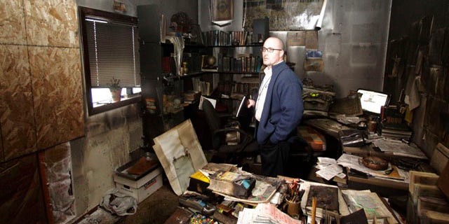 Nov. 28: Cpt. Jonathan Sassman of the Corvallis Police Department looks over fire damage at the Salman Al-Farisi Islamic Center in Corvallis, Ore., where an alleged arsonist set a fire in the early morning hours.