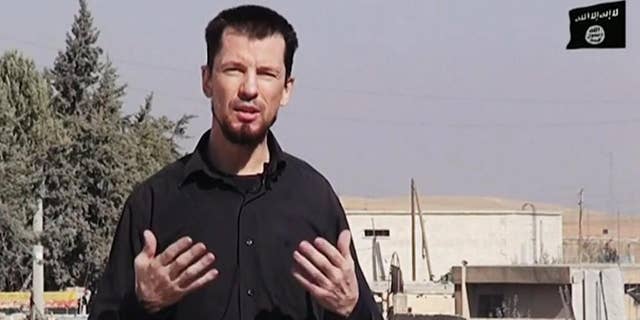 In this still image taken from an undated video published on the Internet by the Islamic State group militants, captive British journalist John Cantlie speaks into a camera in what he identifies as the embattled Syrian town of Kobani. In the video, Cantlie says Islamic State fighters have pushed deeper into the town despite airstrikes by a U.S.-led coalition. It's the latest propaganda video in which Cantlie is exploited by the extremists to take on the role of a war correspondent. AP cannot verify the location independently. (AP Photo)