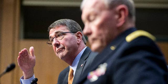 FILE - In this March 3, 2015 file photo, Defense Secretary Ash Carter, left, accompanied by Joint Chiefs Chairman Gen. Martin Dempsey, testifies on Capitol Hill in Washington before the Senate Armed Services Committee. Iran’s growing influence in Iraq is setting off alarm bells, and nowhere is the problem starker than in the high-stakes battle for Tikrit. It marks a crucial fight in the bigger war to expel the Islamic State group from Iraq, and yet Iran and the Shiite militias it empowers _ not the U.S. _ are leading the charge. Carter, under questioning from Sen. John McCain this week, acknowledged his concern when McCain asked if it alarms him that Iran “has basically taken over the fight.” (AP Photo/Manuel Balce Ceneta, File)