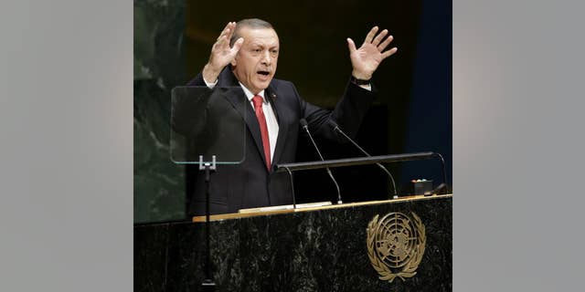 In this Sept. 24, 2014, photo, Turkish President Recep Tayyip Erdogan speaks during the 69th session of the United Nations General Assembly at U.N. headquarters. Moving from reluctance to refusal and finally to acceptance, Turkey is joining its NATO allies and fellow Sunni Muslim nations in a coalition to destroy the Islamic State militant group. But the U.S. is still waiting for details of any new, specific, aid and is warily watching to make sure Ankara keeps its commitments. Erdogan also told reporters on Tuesday, “Of course, we will do our part.” (AP Photo/Seth Wenig)