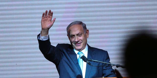 FILE - In this Wednesday, March 18, 2015 file photo, Israeli Prime Minister Benjamin Netanyahu greets supporters at the party's election headquarters In Tel Aviv. Before the elections, Israel had already become a source of division, rather than unity, for American Jews, who bitterly debated the ever-expanding Jewish settlements in Palestinian territories and the acceptable boundaries of dissent from Israeli policies. The outcome of the Israeli election will only deepen that polarization, experts say. Netanyahu's anti-Arab campaign rhetoric and his rejection of a Palestinian state, they say, will further splinter American Jews into hard left and right camps, and intensify conflicts over what it means to be loyal to the Jewish state. (AP Photo/Oded Balilty)