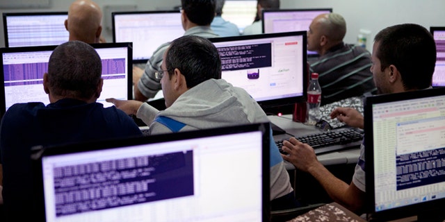 Oct. 20, 2013: Israelis work on computers at the 'CyberGym' school in the coastal city of Hadera. When Israel's military chief delivered a high-profile speech this month outlining the greatest threats his country will face in the future, he listed computer sabotage as a top concern, warning a sophisticated cyber attack could one day bring the nation to a standstill.