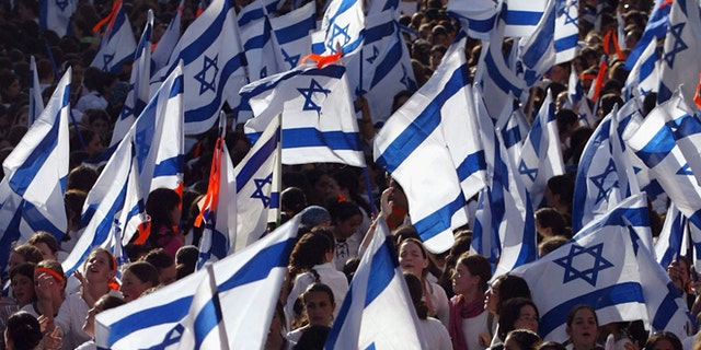 JERUSALEM, ISRAEL - JUNE 06: (ISRAEL OUT) Israeli nationalists wave the flags as they dance and march in the streets during a parade marking Jerusalem Day, June 6, 2005 in central Jerusalem, Israel. Thousands of nationalist Israelis marked Jerusalem Day, the 38th anniversary of the unification of Jerusalem under Israeli rule in 1967. (Photo by Uriel Sinai/Getty Images)