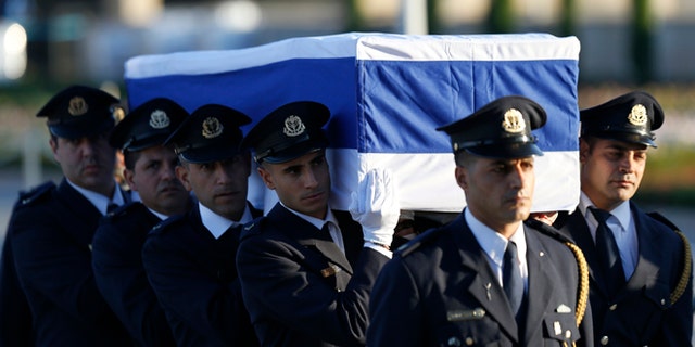 Members of the Knesset guard carry the coffin of former Israeli President Shimon Peres in Jerusalem, Thursday, Sept. 29, 2016.