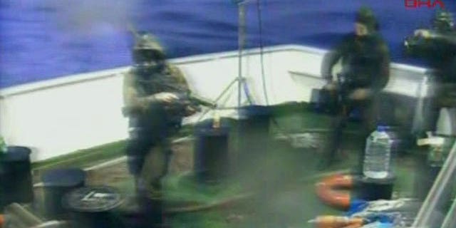 May 31: This video image released by the Turkish Aid group IHH purports to show Israeli soldiers aboard a military vessel in international waters off the Gaza coast surrounding a Turkish ship.