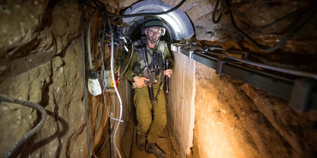 An Israeli army officer gives explanations to journalists during an army organised tour in a tunnel said to be used by Palestinian militants for cross-border attacks.
