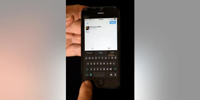 A reporter demonstrates the SwiftKey keyboard on an iPhone.