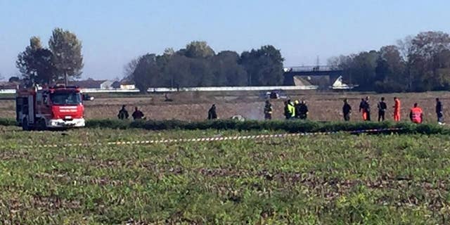Rescue teams operate in the area where an aircraft crashed in a mid-air incident, in Santhia, near Vercelli, Italy, Friday, Oct. 30, 2015. The AgustaWestland helicopter maker says that a prototype of one of its aircraft was involved in a mid-air accident that killed both occupants in northern Italy. (Roberto Maggio/ANSA via AP) ITALY OUT