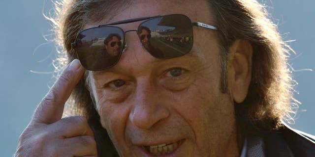 FILE - A Sunday, Dec. 15, 2013 photo from files of the then Cagliari president Massimo Cellino gesturing prior to the Serie A soccer match between Parma and Cagliari at Parma's Tardini stadium. Massimo Cellino _ with his sunglasses and slick, graying hair _ breezed into Elland Road in April when his company, which already owned Italian side Cagliari, bought a controlling stake in Leeds. This was the biggest football team in England in the late 1960s and early ‘70s in the era of Johnny Giles and Billy Bremner, the league champion in 1992 when Eric Cantona starred up front and a Champions League semifinalist only 12 years ago. (AP Photo/Marco Vasini, File)