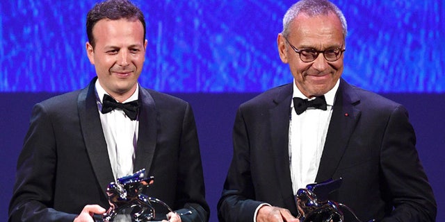 Mexican film director, producer and screenwrite Amat Escalante, left, holds the Silver Lion award for his movie "La Region Salvaje" (The Untamed) flanked by Russian director Andrei Konchalovsky, holding the Silver Lion award for his movie "Paradise" during the awards ceremony of the 73rd Venice International Film Festival, in Venice, Italy, Saturday, Sept. 10, 2016. (Ettore Ferrari/ANSA via AP)