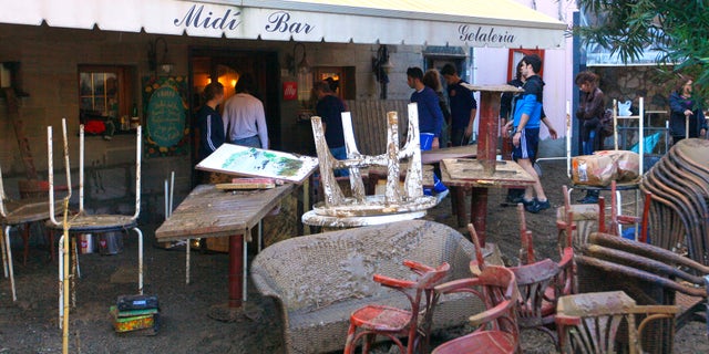 Oct. 26, 2011: Mud covered tables are seen stacked outside a bar in Monterosso, Italy.
