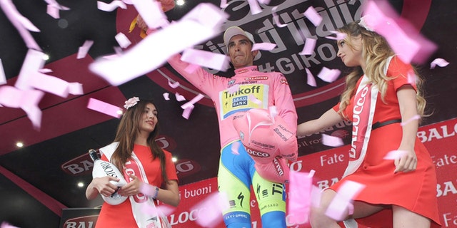 Overall leader Spain's Alberto Contador celebrates on podium after retaining the pink jersey ov leader during the eight stage of the Giro d'Italia, Tour of Italy cycling race from Fiuggi to Campitello Matese, Italy, Saturday, May 16, 2015. (Daniel Dal Zennaro/ANSA via AP) ITALY OUT