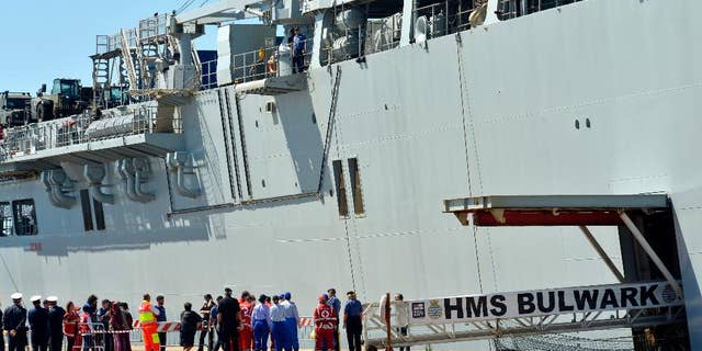 Migrants disembark from the British Naval ship HMS Bulwark at the Taranto harbor, Italy, Saturday, May 30, 2015. (AP Photo/Gaetano Lo Porto)